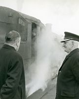 20 Station Master Tony Ryan with Peter Mc Ardle watching last steam train leaving Dundalk.