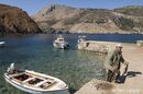 A fisherman with his catch in the harbour of Porto Kagio, in the deep Mani, Southern Peloponnese, Greece.<br><br><br><br><br><br>