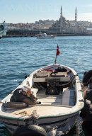 A boatman surveys the scene across the Golden Horn from Karakoy waterfront, Istanbul.<br><br><br><br><br><br>