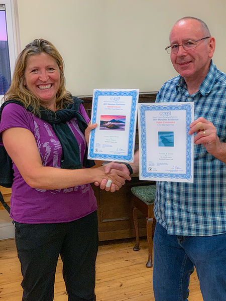 Chairperson presenting Jen with Certificates