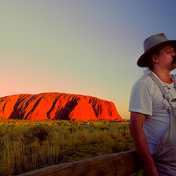 Beer drinking Australian not looking at the sun setting on Ayers Rock 1989