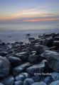 Rocky seashore at dusk, Llantwit Major, south Wales.