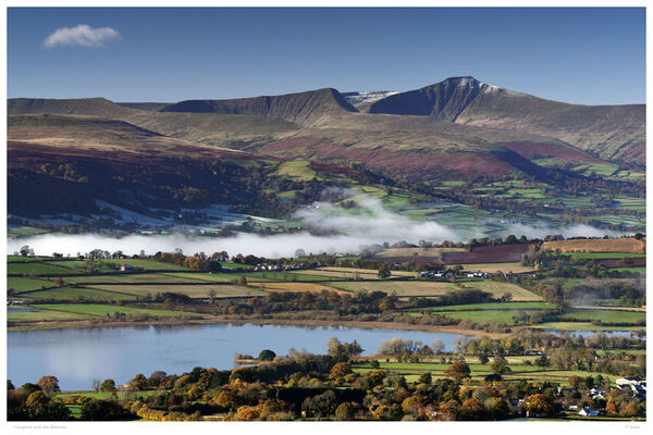 Brecon Beacons and Llangorse Lake in Autumn. Brecon Beacons and Llangorse Lake in autumn with early morning mist drifting across the valley floor..
