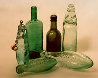 Derek Tostevin DPAGB, BPE1 Still Life Six Green Bottles