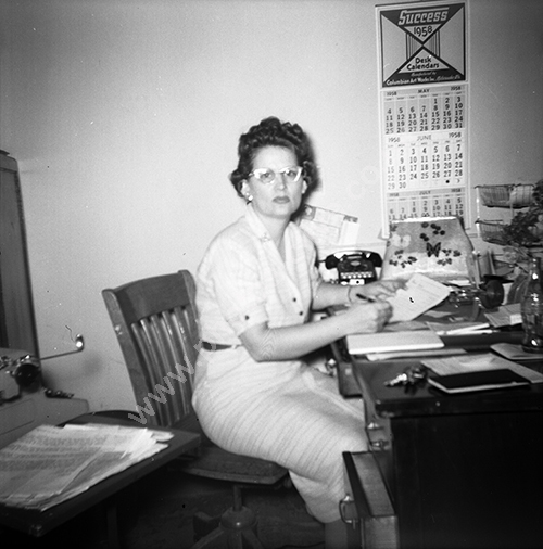 office worker with 1958 calendar.