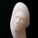 stone carving of a female head in pink alabaster