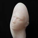 stone carving of a female head in pink alabaster