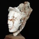 stone carving of a female head in white and brown marble