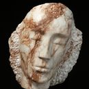stone carving of a female head in white and brown marble