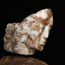stone carving of a female head in white and brown marble