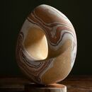 ring shaped stone carving made of rainbow sandstone