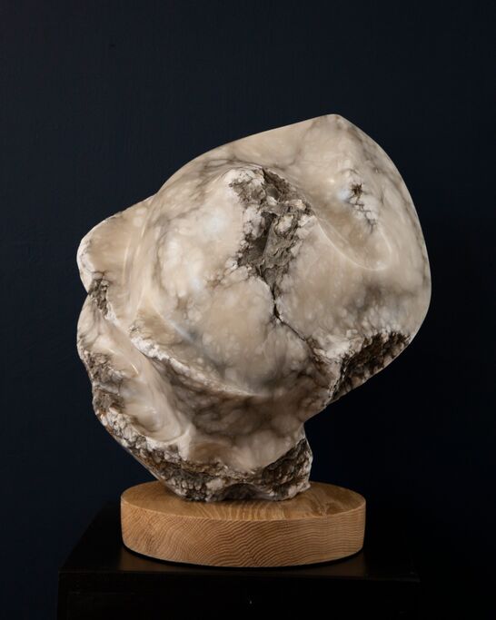 an abstract free-carved form in white alabaster