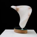 a helical form carved in alabaster and mounted on a mirror