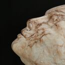 stone carving of a female head in marble