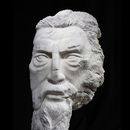 white marble stone carving resembling Greek god Zeus