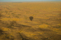 Shadow of Hot air Balloon over desert