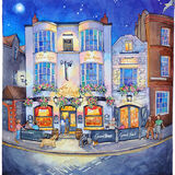 A glowing night time view of the Cricketers Pub, Brighton