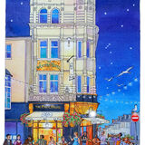 A glowing night time view of the Paris House Pub, Brighton