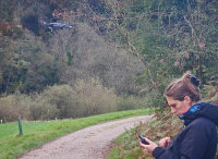 Kashfi Halford using drone for overhead view of wood