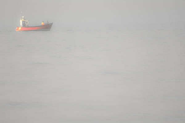 Red boat in the mist