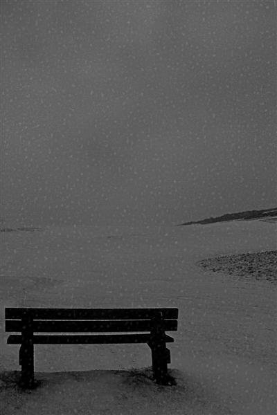 Snow covered bench on 1st tee
