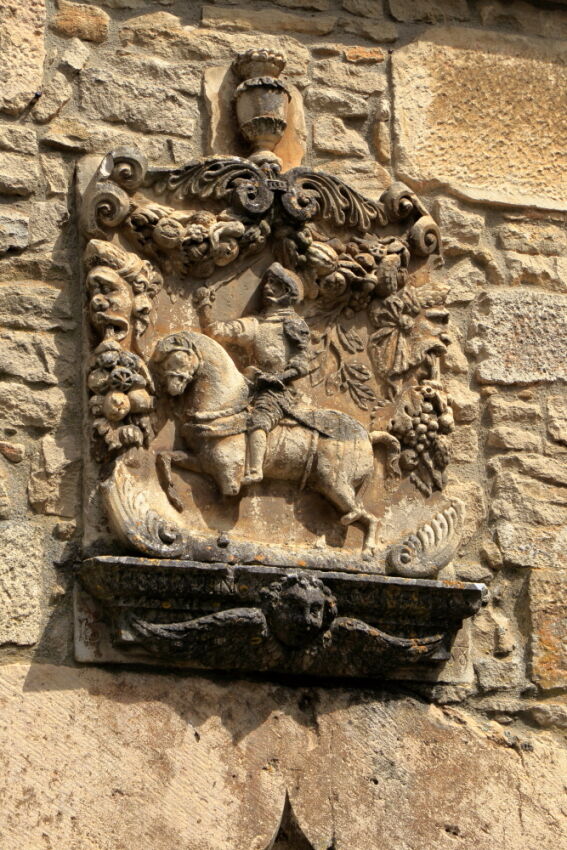 Decorative stone carving of knight in armour on horseback