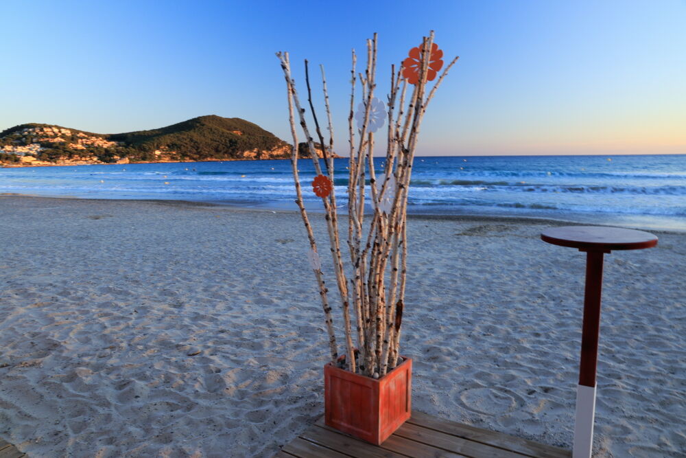 Beach café ornament at Les Lecques, evening, Pointe Grenier in distance