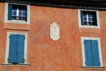 Sundial with Latin motto and shutters on house at Sainte-Cécile-les-Vignes