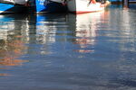 Reflections of fishing boats in the water at Scarborough Harbour
