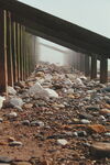 Mist and stones on beach under groynes at Spurn Point