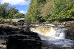 Stainforth Force Waterfall on River Ribble at Stainforth Force, with packhorse bridge in background