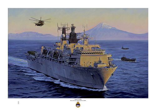 HMS Albion at sea with Mount Fuji in the background and the sun going down.