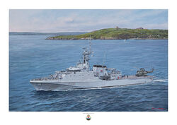 HMS Tamar port side aerial view with Puma helicopter on deck and Falmouth on the horizon