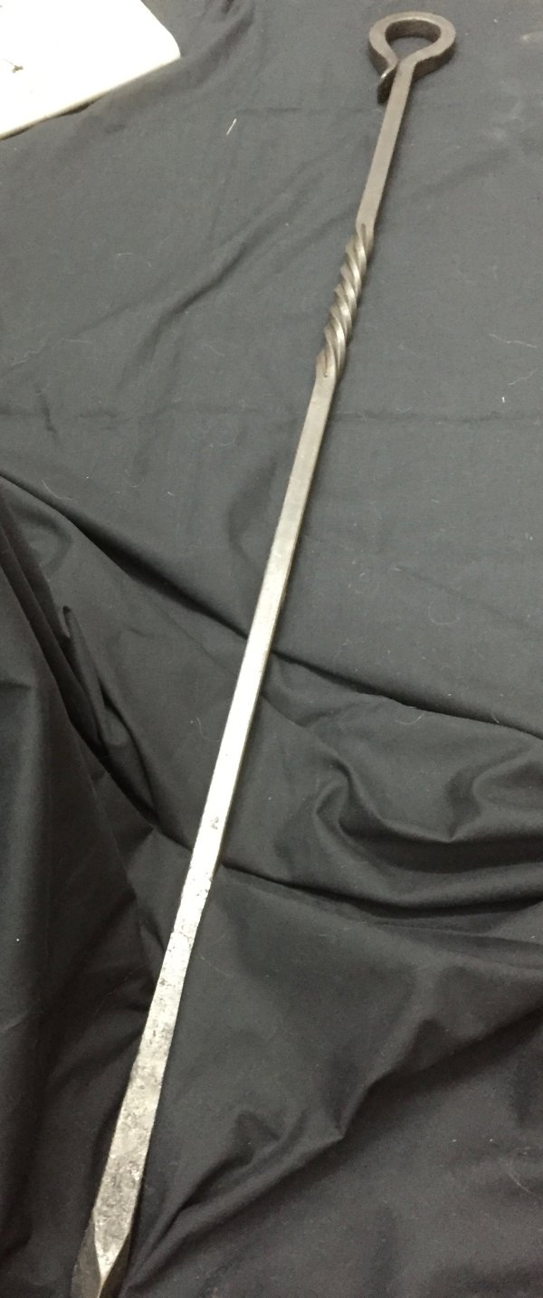 Long fire poker in blackened hand forged iron