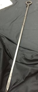 Long fire poker in blackened hand forged iron