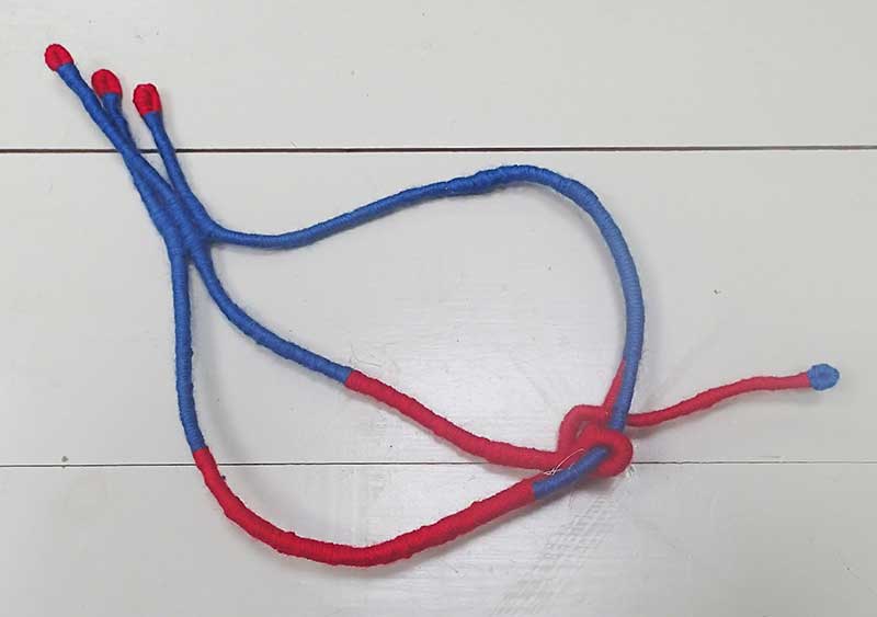 blue red wrapped esparto grass by Tadek Beutlich