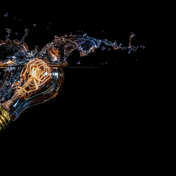 steve-shelley-ssshoot-covid-lockdown-007 illuminated light bulb dropped in water with high speed flash photography