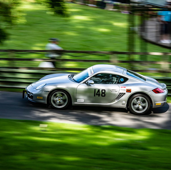 Porsche at Prescott 2019, #06 silver porsche cayman at speed during the porsche at prescott hill climb event