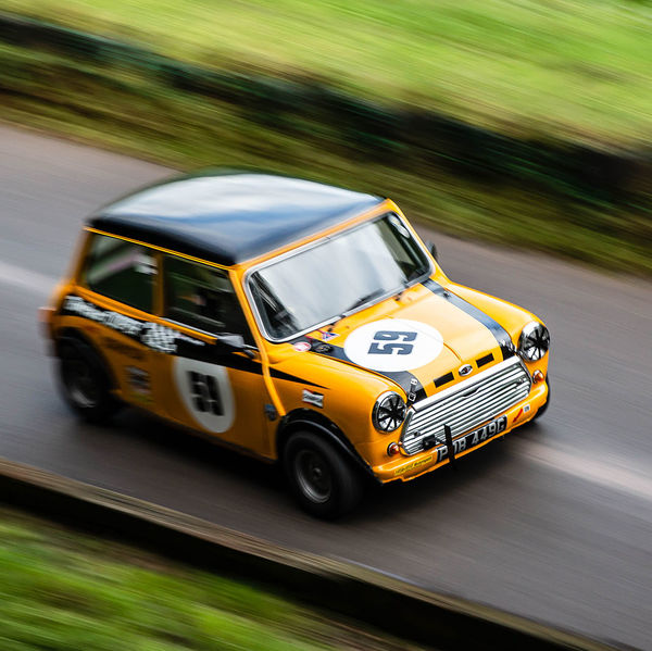 Classic Nostalgia 2019, Shelsley Walsh Hill Climb, #05 orange mini cooper s racing car at speed on shelsley walsh hill climb circuit