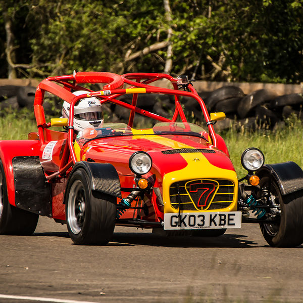 Lotus 7 Club Speed Championships, Curborough, #26 red and yellow caterham 7 at speed through curborough sprint course mole hill corner