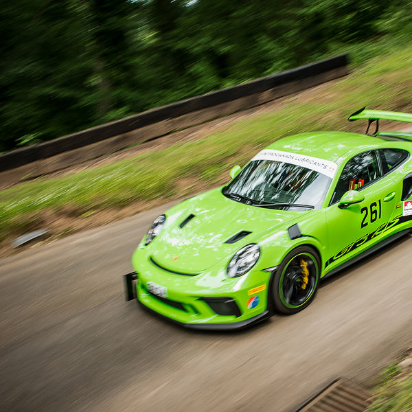 Best of British 2019, Shelsley Walsh, #46 green porsche GT3 RS race car decending shelsley walsh hill climb at speed