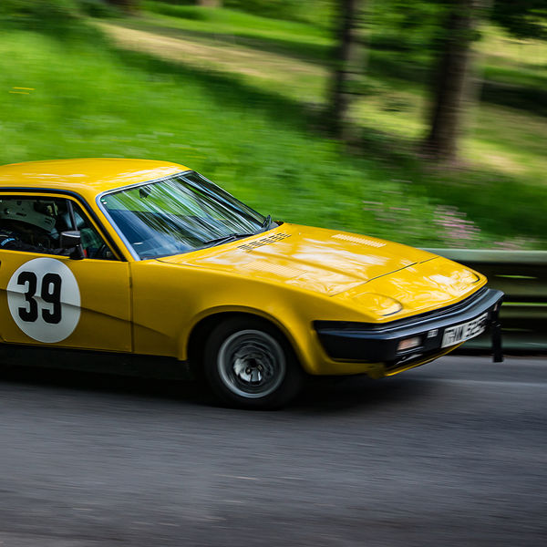 La Vie en Bleu 2019, Prescott Speed Hill Climb, #35 yellow classic triumph TR7 taking a corner at speed on the famous prescott hill