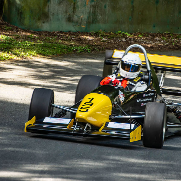 Porsche at Prescott 2019, #16 yellow single seat racing car at speed during the porsche at prescott hill climb event