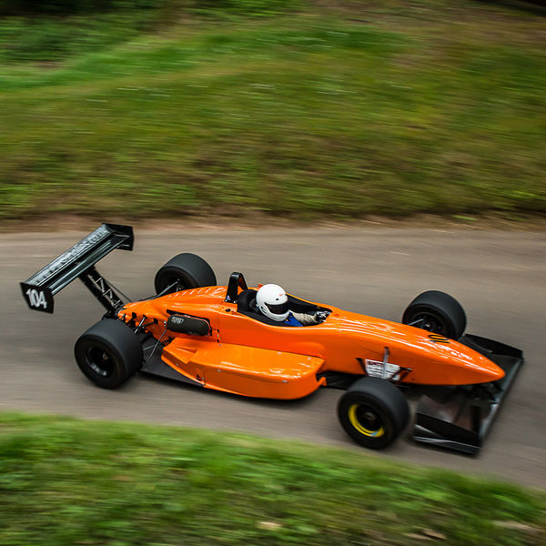 Best of British 2019, Shelsley Walsh, #39 orange single seat racing car rounding top esses at shelsley walsh hill climb at speed