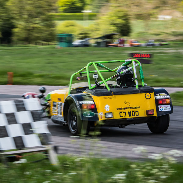 Lotus 7 Club Speed Championships, Curborough, #11 Yellow Caterham 7 at speed past the chequered flag at shenstone sprint course