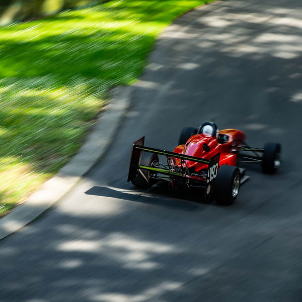 Porsche at Prescott 2019, #61 red single seat race car at speed during the porsche at prescott hill climb event