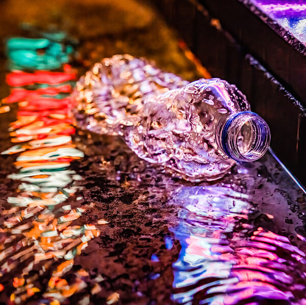 steve-shelley-ssshoot-covid-lockdown-006 plastic bottle trash in the street during rain with light reflections