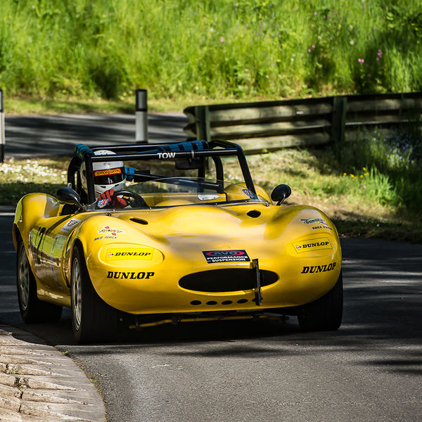 La Vie en Bleu 2019, Prescott Speed Hill Climb, #14 bright yellow ginetta sports car at speed through the corners at prescott hill climb