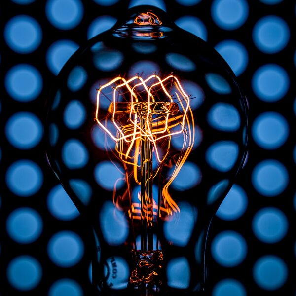 steve-shelley-ssshoot-covid-lockdown-034 vintage light bulb with orange filament and blue polka dot reflections