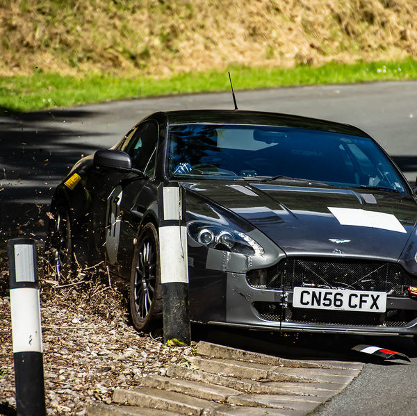 Porsche at Prescott 2019, #13 grey aston martin clattering the bollards at speed during the porsche at prescott hill climb event